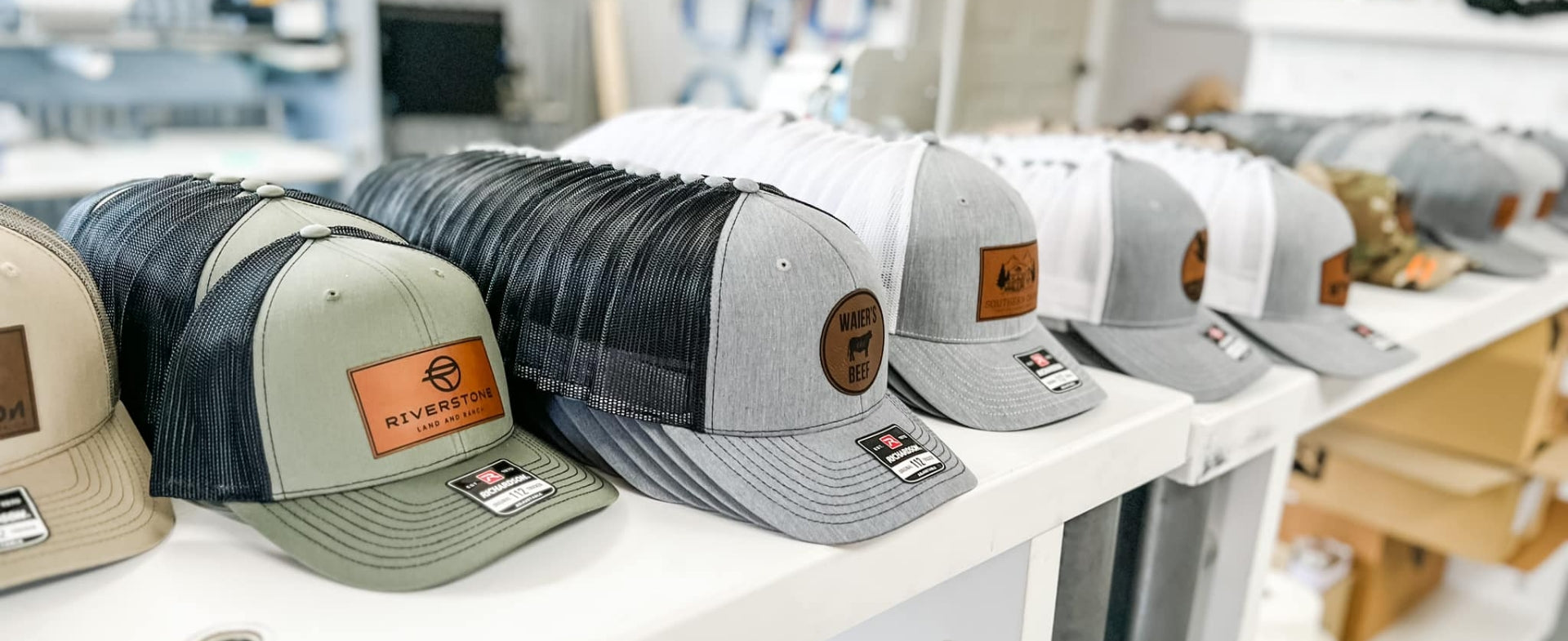 rows of different hats with custom patches