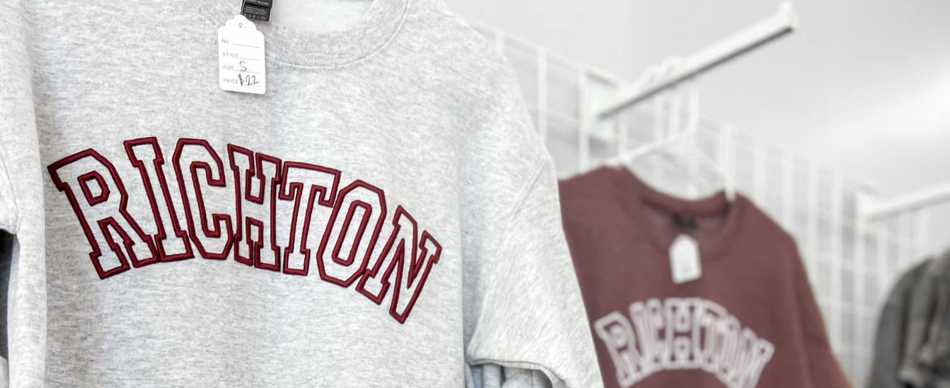 grey sweatshirt with "Richton" embroidered on it