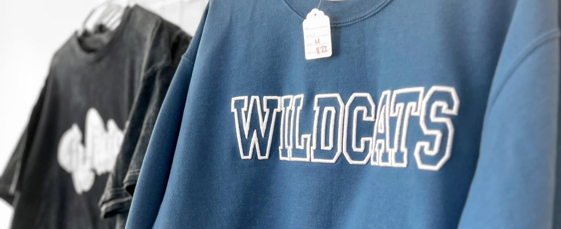 blue sweatshirt with "wildcats" embroidered on it