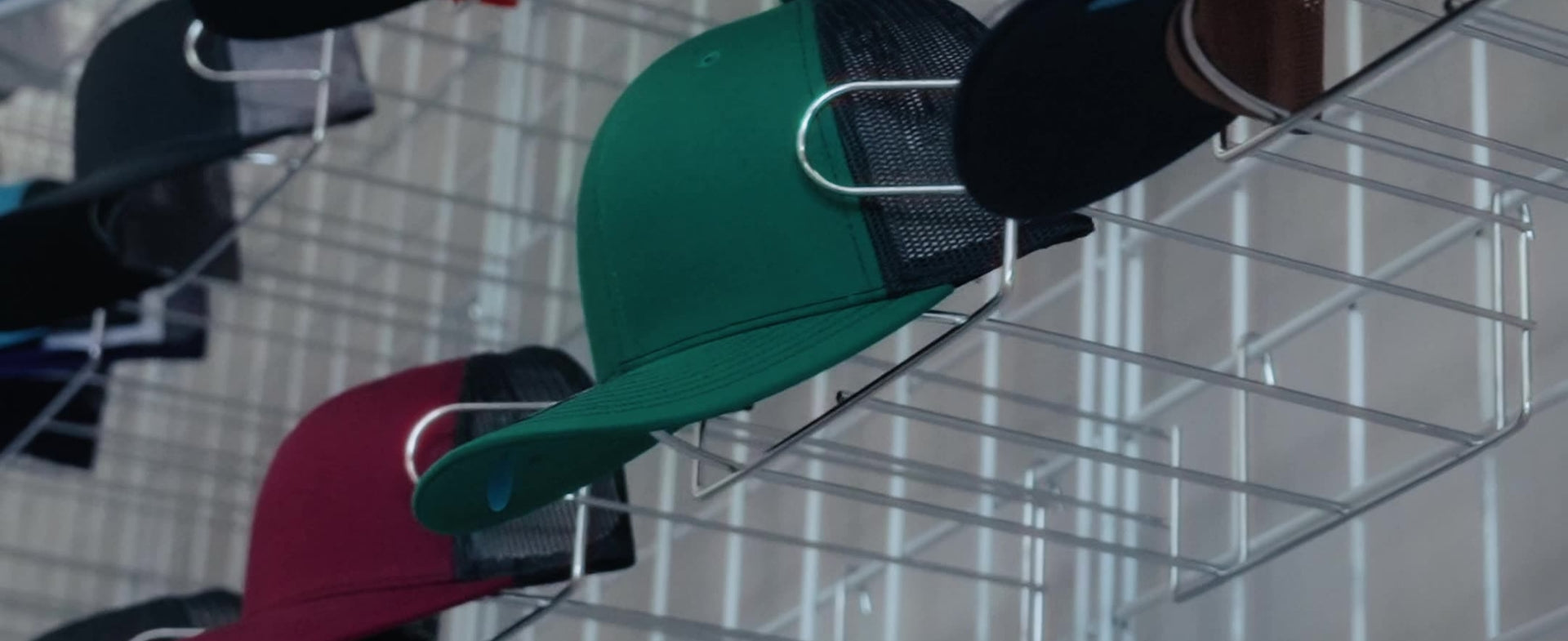 hats on a rack at Laserly Merch Co.