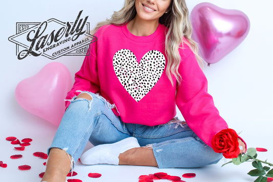 Model wearing a pink sweatshirt with a polka dot heart