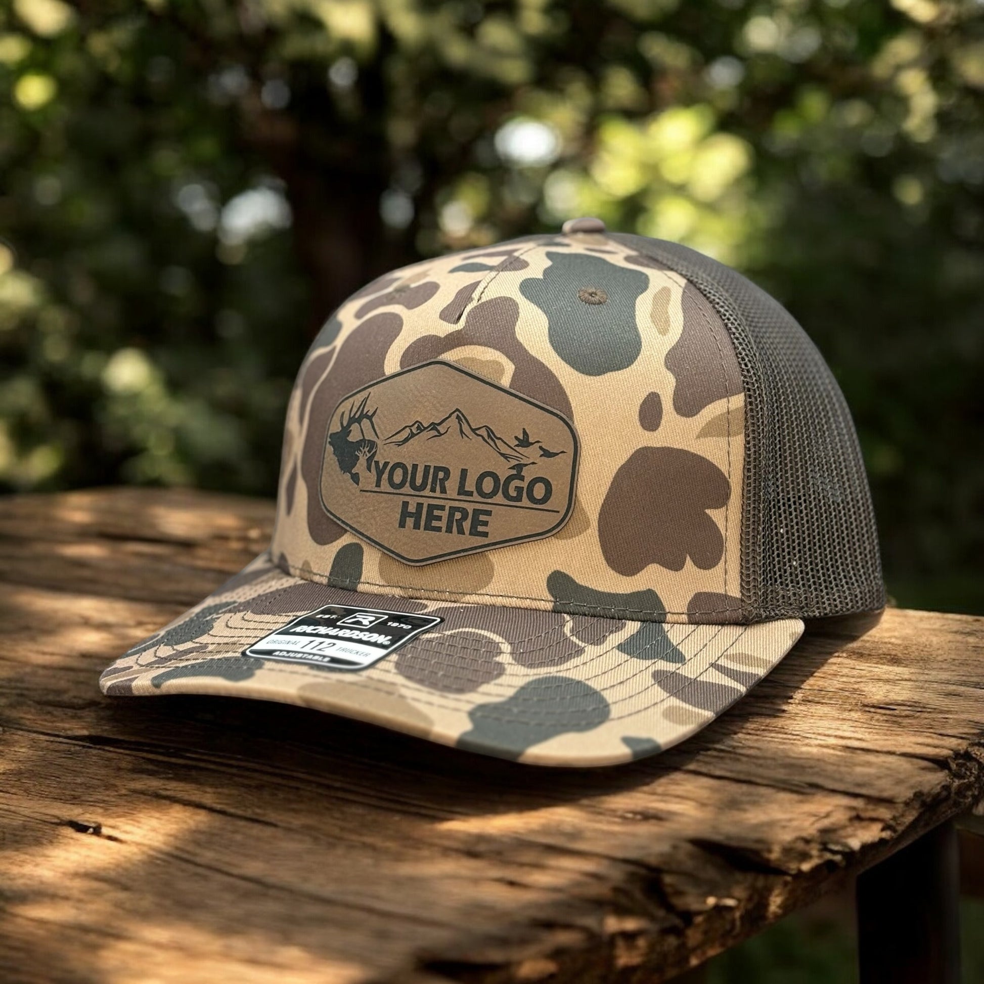 Camo hat with a custom patch outdoors