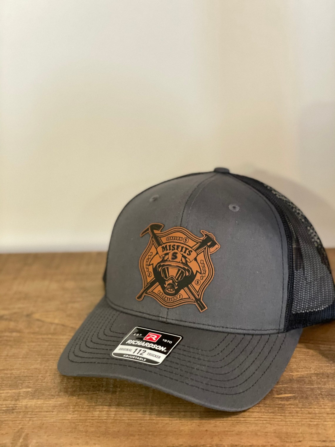 grey hat with a logo on patch