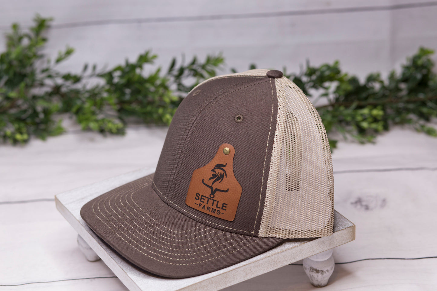 brown hat with custom cattle tag patch side view