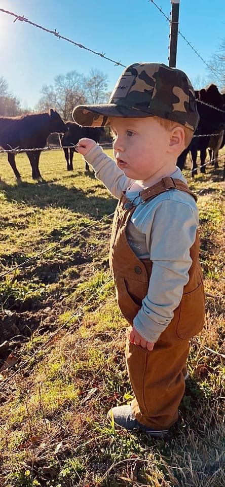 kid model wearing a camo custom name patch hat