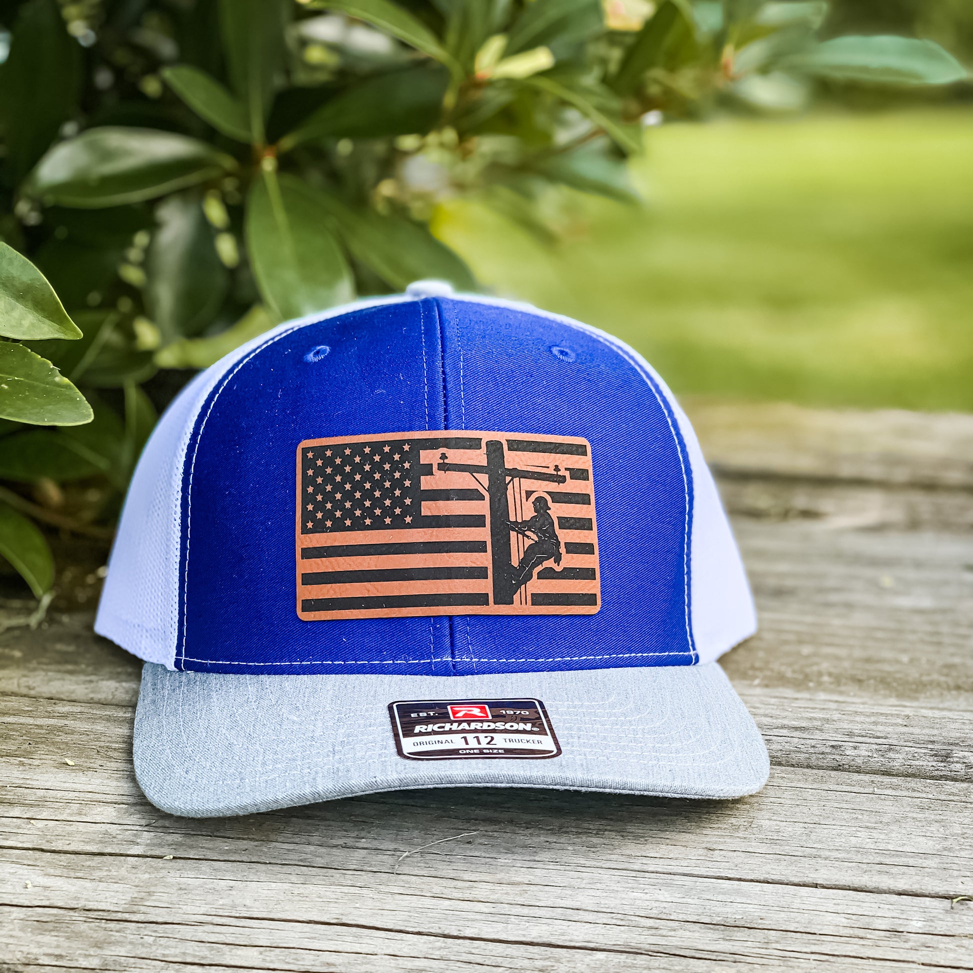 blue hat with an American Flag and lineman patch